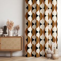 a living room with a brown and white curtain next to a wooden cabinet in front of it