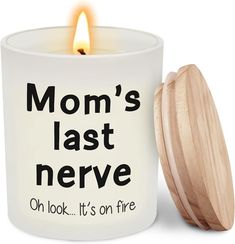 a candle that is next to a jar with a lid on it and the words mom's last nerve