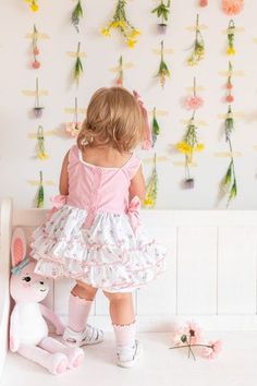 Discover springtime sweetness with our delightful baby girls’ Easter romper. Featuring a sweet little Easter basket, pink bows on the sides, and a playful spring floral print with layers of ruffles. Pre-Order item only: This item is for pre-order. Secure your size by placing a pre-order for this item. We will ship your items promptly when they arrive at our shop. Our orders were placed this past year and all styles/sizes you see under pre-order should arrive to our shop in the next 2 weeks. Please allow 2 weeks for all pre-order items. If there are any delays, we will contact you directly. If you are purchasing multiple items with your pre-order, please be aware we will bundle your items and ship complete. Sizing: Be Girl tends to fit true to size but slim and vintage cut (short) in length Cute Bubble Romper For Spring Garden Party, Cute Bubble Romper For Garden Party In Spring, Spring Garden Party Bubble Romper With Ruffles, Cute Bubble Romper With Ruffle Hem For Spring, Cute Spring Bubble Romper With Ruffle Hem, Spring Bubble Romper With Ruffles For First Birthday, Spring Bubble Romper For Garden Party, Spring First Birthday Bubble Romper With Ruffles, Cotton Bubble Romper For Spring Garden Party