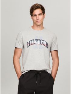 Tommy Hilfiger men's T-shirt. Made from lightweight cotton jersey, known for its breathability and stretch, our comfortable crewneck tee is cut in an easy fit and finished with our Hilfiger graphic.  Material: 100% Cotton. Tommy Hilfiger Graphic Print T-shirt For Streetwear, Tommy Hilfiger Logo Print T-shirt For Streetwear, Tommy Hilfiger Sporty T-shirt With Graphic Print, Tommy Hilfiger Sporty Graphic Print T-shirt, Tommy Hilfiger Sporty T-shirt For Summer, Tommy Hilfiger Sporty Summer T-shirt, Tommy Hilfiger Relaxed Fit T-shirt With Graphic Print, Tommy Hilfiger Crew Neck T-shirt With Logo, Tommy Hilfiger Cotton T-shirt With Text Print