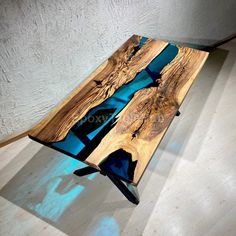 a table made out of wood with blue ribbon on it and light coming through the top