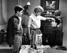 two boys and an older woman standing in front of a dresser with the words 7 ways one mom is raising good guys