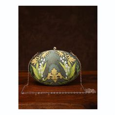 This is one of a kind handcrafted bag which is handcrafted to order. As it is a handcrafted product, it may have slight irregularities or imperfections.  MEASUREMENTS Length - 17.78cm Width - 22.86cm Handle - 57.15cm This clutch can be worn as a crossbody bag or a shoulder bag with the sling chain or can simply be carried in hand. It is spacious enough to carry mobile phones, cosmetics, keys and other small accessories. Unique Green Bag As A Gift, Unique Green Bag For Gift, Handmade Unique Green Bags, Elegant Hand Painted Rectangular Bag, Elegant Hand Painted Rectangular Bags, Handheld Handmade Bag For Formal Occasions, Unique Handmade Evening Bags, Artisan Green Shoulder Bag As Gift, Handmade Pouch Shoulder Bag For Formal Occasions