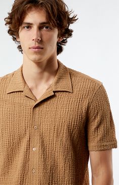 PacSun introduces the Pointelle Textured Woven Camp Shirt, showcasing a collared neckline and button-up front for a classic look. Crafted from crinkled fabrication, this shirt features short sleeves, offering both comfort and style in one piece.


	Collared neckline
	Short sleeves
	Button closures
	Standard fit
	Crinkle fabric
	97% polyester, 3% spandex
	Machine washable
	Model is wearing size medium
	Model Measurements: 6’1”  Height, 30” Waist, 35” Hips Summer Top With Collar And Placket, Casual Button-up Shirt With Seamless Collar, Collared Shirt With Placket For Summer, Summer Collared Camp Shirt For Workwear, Summer Collared Shirt With Placket, Summer Workwear Camp Shirt With Collar, Summer Workwear Collared Camp Shirt, Summer Shirt With Johnny Collar And Buttons, Spring Short Sleeve Shirt With Johnny Collar