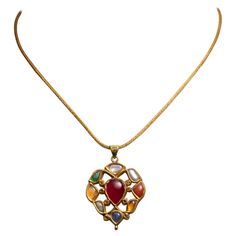 A 22K gold pendant with precious and semi-precious gemstones depicting the Nava Ratna mythology on one side and kundan gold and enamel work depicting flowers on the reverse. The pendant hangs from a hand-rolled 22K gold chain which has a screw-off end to allow for interchanging pendants. The pendant itself measures .75" x 1.75" on a 16.5" chain. India, Mid 1900's. The mythology of the Nava Ratna is quite auspicious, royal and sacred to most Asian countries, regardless of differences in culture and religion. It brings balance and benefit to the wearer. The stones relate to deities and celestial bodies. The following is a translation: 1. Ruby for Surya (Sun), 2. Pearl for Chandra (Moon), 3. Red Coral for Mangala (Mars), 4. Emerald for Budha (Mercury), 5. Yellow sapphire for Brhaspati (Jupite 22k Gold Chain, Asian Countries, Gold Piece, Fine Jewelry Collection, Yellow Sapphire, Red Coral, Nantucket, 22k Gold, Semi Precious Gemstones