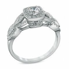 Capture the romance of the day with this vintage-inspired Celebration Ideal diamond engagement ring. Crafted in 14K white gold, this dazzling design showcases a 1/3 ct. Celebration Canadian Ideal diamond with a color rank of I and clarity of I1. The ideal cut of this diamond is designed to brilliantly enhance sparkle and shine. Additional diamonds create a cushion-shaped border and line the ring's marquise frame and milgrain-detailed split shank. Compelling with 3/4 ct. t.w. of diamonds and a bright polished shine, this comfort-fit engagement ring is a keepsake. Due to the nature of pre-owned jewellery, the ring you choose may have been previously sized. Ring styles from our pre-owned jewelry inventory are sold at their current size and cannot be resized at purchase. As this inventory cons Anniversary Fine Jewelry Halo Ring With Diamond Cut, Cushion Cut Brilliant Cluster Ring For Anniversary, Cushion Cut Cluster Ring With Brilliant Cut For Anniversary, Timeless Diamond Cut Cluster Ring For Wedding, Timeless Cluster Ring With Diamond Cut For Wedding, Classic Halo Ring With Brilliant Cut For Wedding, Heirloom Halo Diamond Ring For Wedding, Heirloom Wedding Diamond Ring With Halo, Classic Brilliant Cut Halo Ring For Wedding