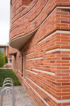 a red brick building with a metal hand rail