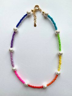 The necklace to cheer you up. Having a bad day? Wear this rainbow on your neck and you will soon feel better. Pearls of Mallorca are mixed with the colourful beads, the length is adjustable thanks to the extension and the details are gold plated 925 silver. Flexible necklace, nickel free: colourful rainbow beads; round and smooth pearls of Mallorca; 21k gold plated 925 silver components as closure, rings and extension. Length: 38 cm (plus 3,5 cm extension).   This item is handmade, color and len Trendy Rainbow Beaded Necklace, Multicolor Round Beads Fun Necklace, Trendy Rainbow Beaded Necklaces With Round Beads, Fun Multicolor Round Bead Necklaces, Trendy Rainbow Beaded Necklace With Round Beads, Adjustable Rainbow Necklace With Colorful Beads, Rainbow Beaded Chain Necklace Trendy Style, Rainbow Beaded Necklace With Heart Beads, Rainbow Heart Beads Necklace