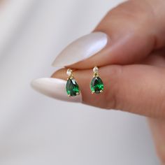 Elevate your jewelry collection with our exquisite 14K Solid Gold Solitaire Diamond Drop Stud Earring, beautifully adorned with a vibrant emerald, the birthstone of May. Each earring features a meticulously set genuine diamond on top, leading the eye to a stunning solitaire emerald that dangles with every movement, capturing light and admiration alike. This piece is not just an accessory; it's an elegant statement, perfect for celebrating a May birthday or marking a special occasion. Crafted fro Cubic Zirconia Teardrop Earrings For May Birthstone, May Birthstone Teardrop Cubic Zirconia Earrings, Pear-shaped Earrings For Anniversary With May Birthstone, Pear-shaped May Birthstone Earrings For Anniversary, Emerald Pear-shaped Fine Jewelry Earrings, Anniversary Pear-shaped May Birthstone Earrings, Pear-shaped Emerald Earrings For Anniversary, Fine Jewelry Earrings For May Birthstone Gift, Hypoallergenic Pear-shaped Earrings Gift