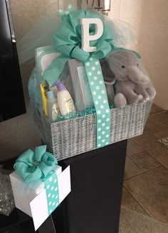 a baby gift basket sitting on top of a dresser