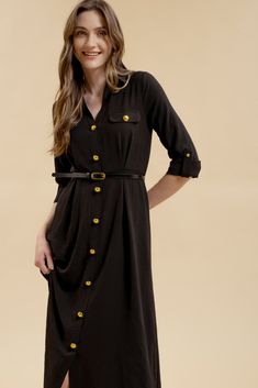 Get ready to stand out in the Monica Midi Dress, featuring a collared neckline and button down front. With gold buttons and hardware, this dress comes complete with a belted waist and pintuck details for a flattering silhouette. The long sleeves with cuff and tab detail, along with the midi length, make this a versatile shirt dress for any occasion. Plus, it even has pockets for added convenience! Semi-formal Button-up Dress With Button Cuffs, Black Long Sleeve Belted Dress For Spring, Black Belted Midi Dress For Semi-formal Occasions, Long Sleeve Midi Dress With Buttons For Semi-formal Occasions, Formal Fall Shirt Dress With Belted Cuffs, Formal Shirt Dress With Belted Cuffs For Fall, Black Belted Dress For Office In Spring, Black Belted Dress For Office And Spring, Belted Shirt Dress For Semi-formal Fall Occasions