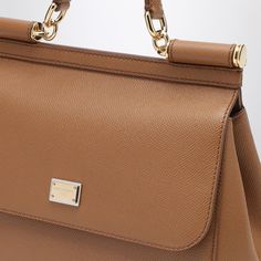 Medium handbag by Dolce & Gabbana in caramel grained leather, featuring frontal flap, hidden snap closure, handle, adjustable and removable shoulder strap, label with logo, internal zip pocket with logo, pocket for the smartphone and metal feet.Width 26 cm x Height 21 cm x Depth 12 cm Adjustable shoulder strap length min 103 cm - max 120 cm Handle drop: 8 cm100% Calf leather Medium Handbags, Bottega Veneta Shoulder Bag, Caramel Color, Louis Vuitton Shoulder Bag, Crossbody Tote, Womens Crossbody Bag, Leather Gloves, Chanel Handbags, Bag Women