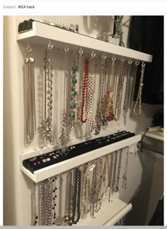 a white shelf filled with lots of necklaces and bracelets on it's sides