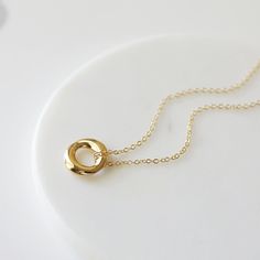 "Beautiful and lovely gold pendant necklace. Made of small gold circle pendant with skinny gold plated brass chain. Soft and warm. Great for gift, everyday or special occasion. Your item will ship in a gift box. Please feel free to contact me if you have any question. ♥ Length 15\" - 20\" ♥ Pendant 5/8\" ♥ Gold plated over brass ♥ See more Rudiana Accessories Rudiana.etsy.com" Gold Minimalist Open Circle Necklace, Minimalist Gold Open Circle Necklace, Everyday Yellow Gold Circle Charm Necklace, Gold Circle Charm Necklace For Gift, Simple Gold Charm Necklaces For Bridesmaids, Gold Charm Necklace For Bridesmaid Gift, Simple Gold Charm Necklace For Bridesmaids, Gold Delicate Minimalist Charm Necklaces, Tiny Gold Minimalist Charm Necklaces