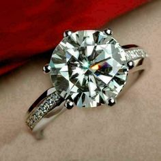 a close up view of a diamond ring with diamonds on it's sidestone