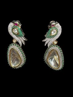 Sabyasachi white bollywood/hyderabadi shaadi dulhan/bold oversized drop/rajasthani jaipur comfortable/vintage boho bohemian A must have for the upcoming wedding season! These earrings are perfect for a modern and fun look for any event. The uncut polki stone is a statement piece this season and the cz stones along with emerald work really make this stand out. These earrings are glamorous as well as easy to wear. White Intricate Design Drop Earrings, Designer Dangle Earrings For Parties, Designer Kundan Earrings For Diwali, Elegant Designer Festive Jhumkas, Elegant Designer Jhumkas For Festive Occasions, Festive Elegant Designer Jhumkas, Elegant Chandbalis For Festivals, Elegant Designer Chandbalis For Festivals, Elegant Designer Chandbali Jhumkas