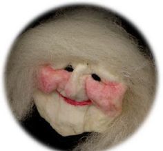 a close up of a stuffed animal wearing a pink bow tie and white hair with a smile on it's face