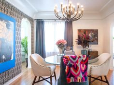 a dining room table with four chairs and a chandelier