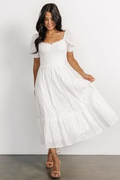 The Piper Eyelet Midi Dress is your go-to staple, seamlessly transitioning from casual outings to special occasions. Crafted from off-white woven material with intricate floral eyelet details, it features a charming sweetheart neckline, smocked bodice, and nursing-friendly design, offering both style and functionality for every moment. Catholic Confirmation Dresses, Mid Length White Dress, Dress Shuffles, Cottagecore White Dress, White Spring Dress, Long Sleeve White Midi Dress, White Engagement Dresses, Hawaii Photoshoot, White Dress Flowy