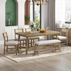 a dining room table with four chairs and a bench