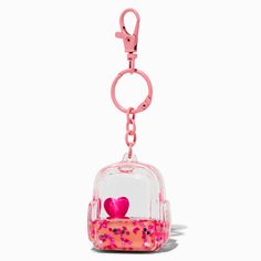 It's so fun to watch the glitter swirl around inside this keychain! Use it to hold your keys (of course) or use the clip to attach it to your purse as a fun bag charm.Length: 3.5 in. / 8.89 cm.Material: Plastic - Claire's Pink Backpack Water-Filled Keychain Emo Accessories, Piercing Kit, Cute Keychains, Cute Emo, Fashionable Jewelry, Bag Charms, Pink Backpack, Slushies, Wallet Accessories