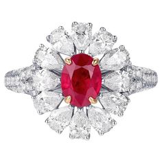 This exquisite ring features a vivid red Burma Ruby weighing 1.13 carats, known for its intense color and high quality. The central ruby, certified by GIA, is described as "Pigeon's Blood," a term used to denote the most desirable and rarest ruby color. Surrounding the ruby are pear-shaped diamonds totaling 1.36 carats, arranged in a striking pattern that enhances the brilliance of the central stone. Additionally, round diamonds with a total weight of 0.42 carats add extra sparkle to the design, Ruby Ring Set, Ruby Diamond Ring, Ruby Color, Ruby Diamond Rings, Art Deco Engagement, Platinum Engagement Rings, Deco Engagement Ring, Ruby Stone, Modern Ring