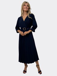 Elegant midi dress with a sophisticated appeal Soft, pleated fabric adds texture and movement Faux wrap top with a flattering V-neckline Three-quarter sleeves with subtle gathering for added elegance Cinched waist with a stylish belt to enhance the silhouette Midi length provides a versatile and timeless look Perfect for both daytime events and evening occasions Complements delicate jewelry and heels for a polished outfit Chic Navy Long Sleeve Midi Dress, Chic Navy V-neck Dress, Formal Navy Midi Dress V-neck, Navy V-neck Midi Dress For Evening, Blue Belted V-neck Maxi Dress, Faux Wrap Top, Elegant Midi Dress, Kate And Pippa, Leggings Hoodie