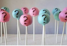 there are many cake pops with question marks on them