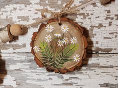 a piece of wood with flowers painted on it