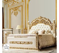 an ornate gold and white bed in a room with large mirrors on the wall, flooring and furniture