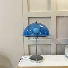 a blue lamp sitting on top of a white table