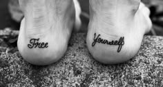 two feet with the words free and yourself tattooed on them