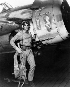 a man standing next to an airplane on top of a wooden floor