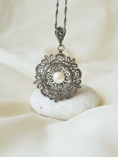 This 925 Sterling Silver Floral filigree pendant is purely handmade and natural Freshwater Pearl is used in the middle. Filigree (Telkari) was a traditional handcraft in Anatolia and Mesopotamia, and still being one of the most important artisan styles in some regions of Turkey, especially in Ankara. Filigree is a kind of jewelry metalwork of silver and gold. Tiny beads and twisted threads are soldered together and arranged in different artistic motifs by silvercraftsmen, thus creating perfectly Ornate Filigree Silver Bridal Necklace, Ornate Silver Bridal Necklace, Ornate Pendant Jewelry For Wedding, Antique Silver Bridal Necklace With Intricate Design, Ornate Bridal Necklace With Intricate Design, Antique Silver Bridal Necklace As Gift, Antique Silver Bridal Necklace Gift, Wedding Necklaces In Antique Silver With Oxidized Finish, Traditional Flower Pendant Jewelry For Wedding