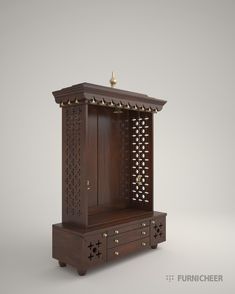 a wooden cabinet with an ornate design on the top and bottom, sitting in front of a gray background