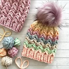 a knitted beanie hat next to yarn and scissors