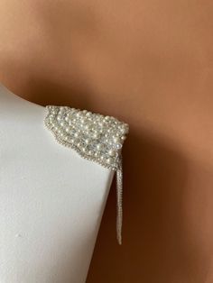 These gorgeous pearl epaulettes are unique and one of a kind piece of shoulder jewelry to go with your wedding dress, party dress or to add a touch of elegance to any formal outfit, letting you sparkle on your special event. Handmade of real pearls and sparkling rhinestones, these shoulder epaulettes will adore your outfit and make you feel like a red carpet celebrity. If you are looking a perfect finishing to your wedding dress, these epaulettes will make your bridal look gorgeous.   No matter Wedding Epaulettes, Elegant Bridal Accessories With Pearl Embroidery For Ceremony, Pearl Embroidered Party Jewelry, Party Jewelry With Pearl Embroidery, Glamorous Beaded Backdrop Necklace For Weddings, Elegant Pearl Embroidery Jewelry For Wedding, Evening Embellished Pearl Jewelry, Elegant Pearl Embroidery Wedding Jewelry, Evening Pearl Jewelry Embellished