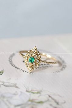 This vintage emerald ring is perfect for any occasion. #vintagejewelry #emeraldring #emeraldjewelry #vintagenegagementrings Elegant 14k Stamped Emerald Ring, Exquisite 14k Gold Cluster Ring, Luxury 14k Gold Emerald Wedding Ring, Classic 14k Gold Flower Ring With Gemstone, Elegant 14k Rose Gold Emerald Ring, Exquisite Yellow Gold Emerald Ring, Elegant Rose Gold Emerald Ring In 14k, Elegant 14k Gold Emerald Cut Birthstone Ring, Elegant 14k Gold Birthstone Ring With Emerald Cut