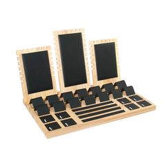 an assortment of wooden frames and magnets in a display case with black squares on them