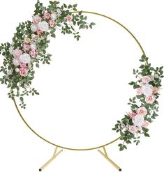 a circular gold frame with pink and white flowers on it, surrounded by greenery