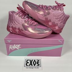 a pair of pink shoes sitting on top of a purple box with the logo rare