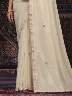 Introducing an exquisite off-white georgette saree that epitomizes elegance and grace, perfect for weddings, festivals, parties, and other special occasions. This beautiful saree is meticulously crafted from high-quality silk georgette fabric, combining the softness of silk with the lightweight and flowy texture of georgette. The off-white hue adds a touch of sophistication, making it a versatile addition to your ethnic wardrobe.
The saree is adorned with intricate sequin work, which shimmers de Festive Off White Blouse Piece With Sheer Dupatta, White Fitted Pre-draped Saree For Eid, Festive Off White Pre-draped Saree, White Anarkali Pre-draped Saree With Intricate Embroidery, Off White Blouse Piece For Reception With Traditional Drape, Off White Traditional Drape Blouse Piece For Reception, White Pre-draped Saree With Resham Embroidery For Wedding, Elegant White Pre-draped Saree For Festivals, White Pre-draped Saree With Zari Work For Eid