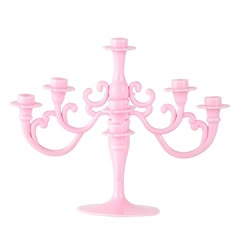 a pink candelabra with five candles on it's sides and one candle holder in the middle