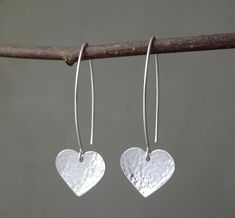 "Simple yet stylish long sterling silver dangle earrings featuring a beautiful hand hammered heart. They will add a lovely touch to any outfit and will make an ideal birthday or anniversary gift. Dimensions: Total length: approximately 4.3 cm (1.6\") Heart: 1.5 cm (0.5\") x 1.3 cm (0.5\") Metal: High quality 925 sterling silver The earrings will come in a beautiful gift box. * CHECK OUT MORE JEWELLERY * www.etsy.com/shop/kailajewellery" Simple Silver Earrings Heart, Silver Earrings Uk, Cold Connections, Jewellery Workshop, Simple Silver Earrings, Silver Smithing, Modern Silver Jewelry, Jewelry Making Classes, Handmade Silver Jewellery