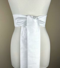 "Wide Textured White Sash Belt  White Dupioni Sash  White Dress Sash  Dupioni Fabric Belt  White Wedding Sash  Formal Dress Sash   Add sophistication and crisp texture to your special occasion outfit with this Satin Swank® dupioni waist sash. Depending on your waist size and the length you choose (75 and 90 inch lengths available), you can wrap this sash around your waist once or twice. You decide whether to tie the sash in a bow or a simple knot with long-hanging tails. Tie in front, in back, o Fitted Bridal Belt With Sashes For Party, White Fitted Bridal Belt For Ceremony, Elegant Fitted Bridal Belt For Bridesmaid, Elegant White Sashes For Ceremony, Elegant White Dresses With Sashes, Fitted Satin Sash For Evening, Elegant White Ceremony Sashes, Elegant Formal Sash With Tie Back, Elegant White Sash For Formal Occasions