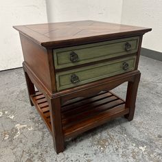 a small wooden table with drawers on it