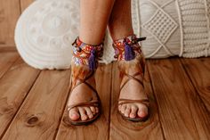 Boho Feather Fringe Sandal Accessories - Purple & Orange Ankle Ties Add a vibrant touch to your summer look with these stunning Purple and Orange Feather Fringe Ankle Ties. Designed for boho fashion lovers, these adjustable ankle wraps instantly elevate any footwear with their unique mix of bold hues and artisan craftsmanship. Perfect for festivals, beach outings, or everyday bohemian style, these accessories transform your sandals into showstoppers. Handcrafted with care, each anklet features p Brown Bohemian Sandals With Ankle Strap, Bohemian Brown Sandals With Ankle Strap, Bohemian Brown Ankle Strap Sandals, Summer Vacation Lace-up Sandals With Heel Strap, Bohemian Ankle Strap Summer Heels, Bohemian Ankle Strap Heels For Summer, Bohemian Ankle Strap Heels For Spring, Leather Barefoot Sandals With Ankle Wrap For Summer, Leather Ankle Wrap Barefoot Sandals For Summer