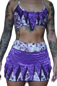 This cute lil two piece pixie set is incredibly stretchy and soft, but will fit small and medium sizes best  Mini skirt has built in booty shorts for extra coverage halter top has adjust ale ties in the back made with natural fibers and fire safe ! Fitted Rave Bottoms With Built-in Shorts, Fitted Purple Skort With Built-in Shorts, Fitted Purple Halter Top For Festivals, Fitted Purple Shorts For The Beach, Fitted Purple Shorts For Beach, Fitted Purple Beach Shorts, Purple Rave Festival Bottoms, Fitted Purple Y2k Bottoms, Black Bratz