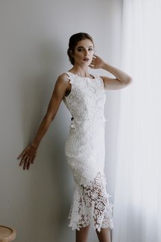 * Ivory Guipure Lace * Square Neckline * Deep V back * Midi Length * Black Satin Bow adornment in back * Zipper closure * Floating Lace pieces * Fully Lined Size Chart: *Bust: 32-34 inches *Waist: 25-26 inches *Hips: 35-36 inches White Sleeveless Gown For Ceremony, Wedding Night Gown With Scalloped Lace And Fitted Bodice, White Gown With Scalloped Lace And Fitted Bodice, Elegant Floor-length Wedding Dress With Lace Back, White Lace Dress With Fitted Bodice For Wedding, White Lace Back Floor-length Wedding Dress, Bridal Gown With Lace Back, Bride's Gown With Lace Back, Elegant Wedding Gown With Delicate Lace