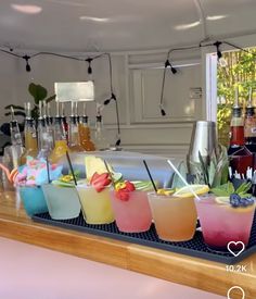 there are many different drinks on the bar